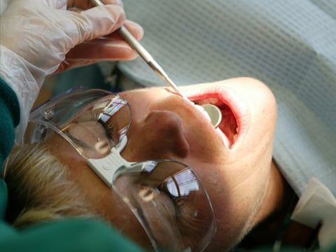 Dentist looking in a woman's mouth